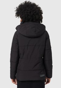 Black puffer jacket with a hood, featuring horizontal stitching, a plush texture, and a branded tag at the bottom left.
