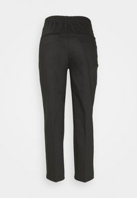 Pantalon noir à jambes droites avec taille élastique et deux poches passepoilées à l'arrière sur un fond clair uni.