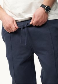 Navy Sweatpants mit elastischem Bund und verstellbarem Kordelzug. Verfügt über Seitennähte und einen weichen, strukturierten Stoff.