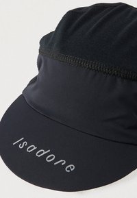 Must mustrteni müts mustrteni eesmise äärega, valmistatud kergest ja hingavast kangast, millel on ääre lähedal peen logo.