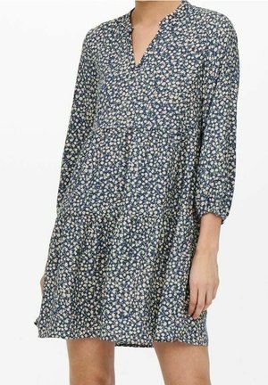 Blaues Blumenkleid mit langen Puffärmeln, einem Notch-Ausschnitt und gestuftem Rock. Hergestellt aus leichtem Stoff und mit kleinen cremefarbenen Blumen versehen.