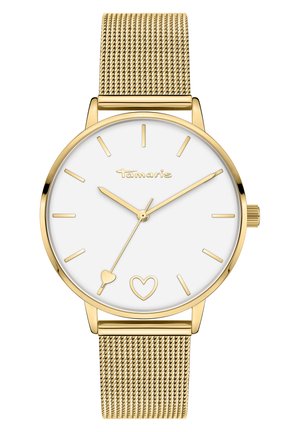 Gold-tone mesh strap wristwatch with a white face, featuring simple hour markers, a minute hand, and heart accents on the dial.