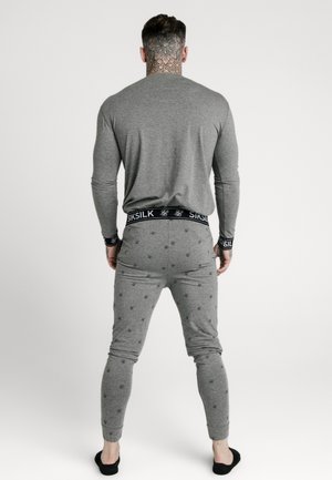 Gray long-sleeve top and matching joggers with a subtle pattern of small designs. Black elastic waistband marked with 'SIKSILK'.