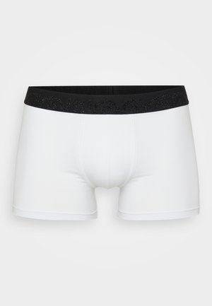 Witte boxershorts met een zwarte elastische tailleband met daarop getextureerde letters. Gladde stof, aansluitend ontwerp en een broekspijp van gemiddelde lengte.
