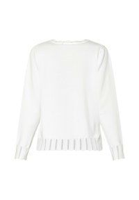 Hvid strikket sweater med bølget udskæring og tekstureret mønster i kanten og ved ærmerne. Lange ærmer med en afslappet pasform.