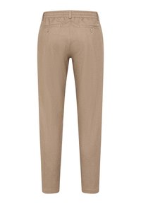 Pantalons beiges à motifs avec une coupe fuselée, taille élastique et deux poches arrière avec des fermetures à bouton.