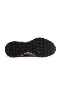 Suola in gomma nera con texture circolari e triangolari. Parte superiore rosa chiaro con fori di ventilazione e logo sul tallone.