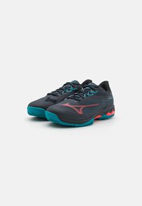 Czarno-skaliste buty sportowe z siateczkową cholewką, teksturowanymi detalami, kontrastującymi czerwonymi akcentami oraz wzorzystą gumową podeszwą.
