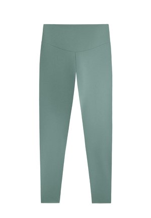 Leggings vert clair en matériau lisse et extensible. Présentent une taille haute et un design ajusté, s'étendant jusqu'à la cheville.