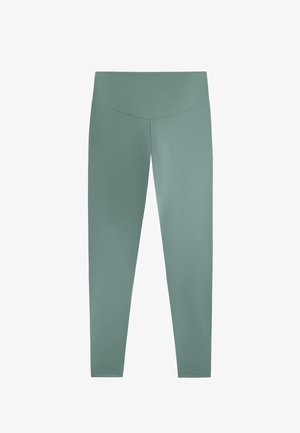 Világoszöld leggingsek sima, rugalmas anyagból. Magas derékkal és testhez simuló kialakítással rendelkezik, és boka hosszig terjed.