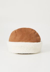 Brown suede hat with a fluffy white shearling cuff. Rounded top with visible stitching and soft texture, suitable for cold weather.