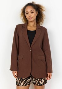 Hnědý blazer na jedno knoflíček s klopou, předními kapsami a volným střihem, doplněný o vzorované šortky. Hladká, lehká tkanina.