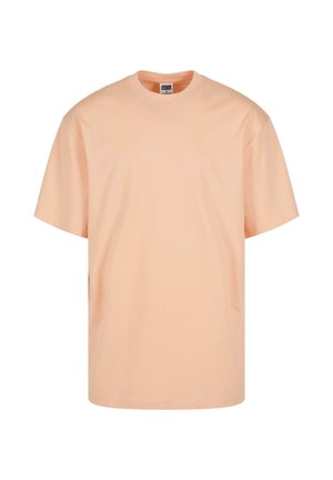 Light peach short-sleeve t-shirt made of cotton. Features a round neckline and a relaxed fit. Smooth texture with no patterns or graphics.