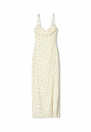 Floral midi dress with thin adjustable straps, cream fabric, vibrant small flower patterns, and a side slit for added detail.