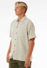 Kortærmet, kravet plaid skjorte i lysebeige og grønne nuancer, med en brystlomme og knaplukning med mørke knapper.
