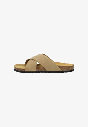 Beige cross-strap sandals with a suede-like upper, cork midsole, and black rubber outsole. Flat design for easy wearing.