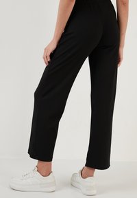 LELA REGULAR FIT - Hlače - black