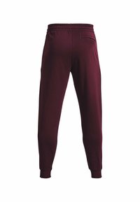 Burgunderfarbene Jogginghosen mit schmalem Schnitt, elastischem Bund und einer einzelnen Gesäßtasche. Hergestellt aus weichem, leichtem Stoff mit gerippten Bündchen.