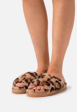 Leopard print faux fur slide slippers with a tan rubber sole and wide cushioned straps, exposing toes and providing a soft texture.