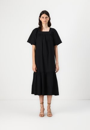 Black, short-sleeve dress with a square neckline, gathered detailing, and a tiered, ruffled hem. Smooth cotton fabric with a structured silhouette.