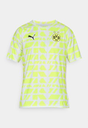 Rövid ujjú mez neon sárga színben, geometrikus mintával, fekete Puma logóval és fekete kör alakú csapatcímerrel a mellkason.