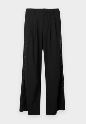 Mustat leveälahkeiset housut, joissa on laskokset ja ohuet sivupaneelit, joissa on hienovarainen graafinen kuvio. Sileää kangasta, suoraleikkainen malli.