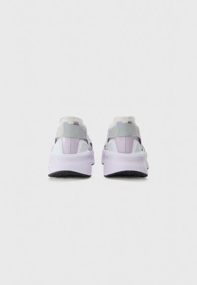 Sport shoes with a light purple and gray design, featuring a cushioned sole, cutout accents, and a textured black rubber outsole.