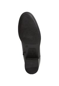 Suela de zapato de cuero negro con texturizado de goma para agarre, un tacón redondeado y un borde liso con un sutil estampado de logo.