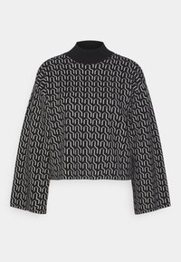 Black and white patterned turtleneck sweater with cropped design and wide sleeves. Features a geometric pattern throughout the fabric.