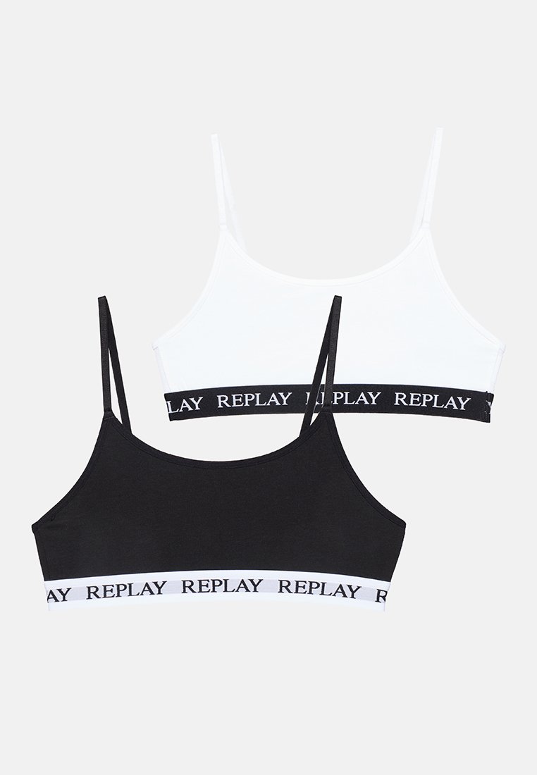 Deux tops courts en mélange de coton noir et blanc. Les deux présentent des bretelles fines et une bande noire avec "REPLAY" imprimé en blanc. Design plat.