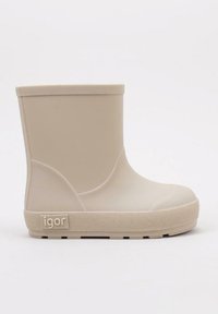 Botte de cheville en caoutchouc beige avec une semelle texturée, un bout rond, un dessus lisse et un petit logo sur le côté. Design minimaliste et durable.