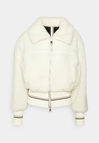 Vit beskuren faux shearling-jacka med silverfärgad dragkedja fram, bred krage, ribbade ärmslut och nederkant med svarta och beige detaljer.