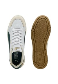 Sneaker Puma con tomaia in pelle bianca, dettagli verde, punta in suede beige, design con lacci e suola in gomma testurizzata color gomma.