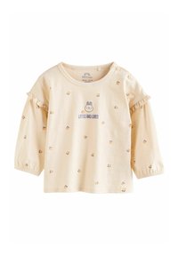 Helles beige Langarmshirt mit Rüschensleeven, das ein Kaninchenmotiv und kleine Blumenmuster zeigt, aus weicher Baumwolle gefertigt.