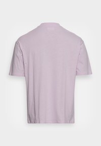 Short-sleeve t-shirt in light lavender, made from soft cotton. Features a crew neckline and a relaxed fit with no notable patterns or accents.