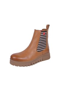 Bottine en cuir tan avec une semelle épaisse, des panneaux latéraux élastiques rayés et un petit accent en forme de cœur rouge sur un côté.
