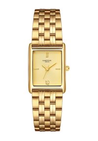 Kuldne ristkülikukujuline kell tekstureeritud dials. Integreeritud metallasjal on harjatud viimistlus ja vahelduvad lingid. Kaubamärgi logo on kohal.