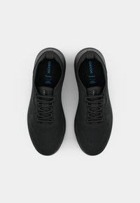 Black athletic shoes with a breathable mesh upper, textured design, and padded collar. Features laces, pull tabs, and a logo in blue.