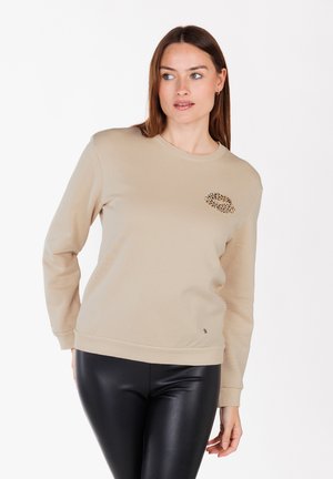 Beige katoenen sweatshirt met een ronde hals, lange mouwen, geribbelde boorden en een luipaardprint detail op de linker borst.