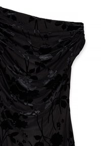 Black floral dress featuring a draped neckline and textured fabric. The design includes a subtle pattern of flowers, creating depth.