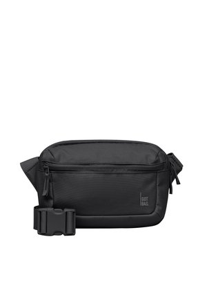 Sac banane noir compact avec poche zippée à l'avant et sangle ajustable avec boucle en plastique, marqué "GOT BAG" sur le côté droit à l'avant.