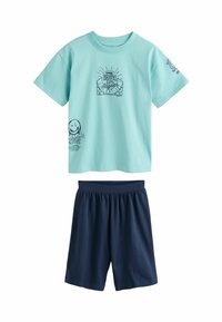 Ljust blå bomullströja med grafik "Skate Los Angeles" och mörkblå shorts. Tröjan har korta ärmar och rund halsringning.