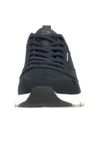 Dark navy athletic shoe with textured fabric upper, round toe, lace-up front, and contrasting white sole. Features minimal branding on tongue.