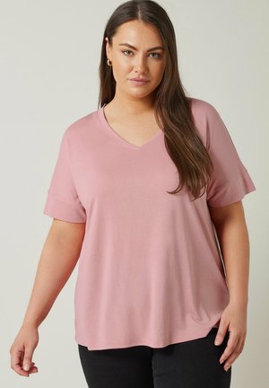 Pink short-sleeve v-neck t-shirt with a relaxed fit and soft texture, featuring a curved hemline and rolled cuffs.