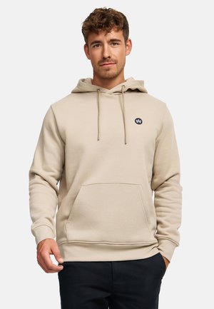 Felpa beige con cappuccio, cordini, tasca frontale e piccolo logo. Tessuto morbido, colore neutro e polsini e orlo a coste.