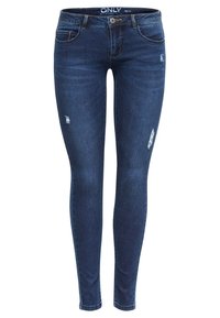 Jeans ajustados de denim azul oscuro con detalles desgastados. Presentan una cinturilla estándar, pasadores para cinturón y cinco bolsillos. Textura suave.