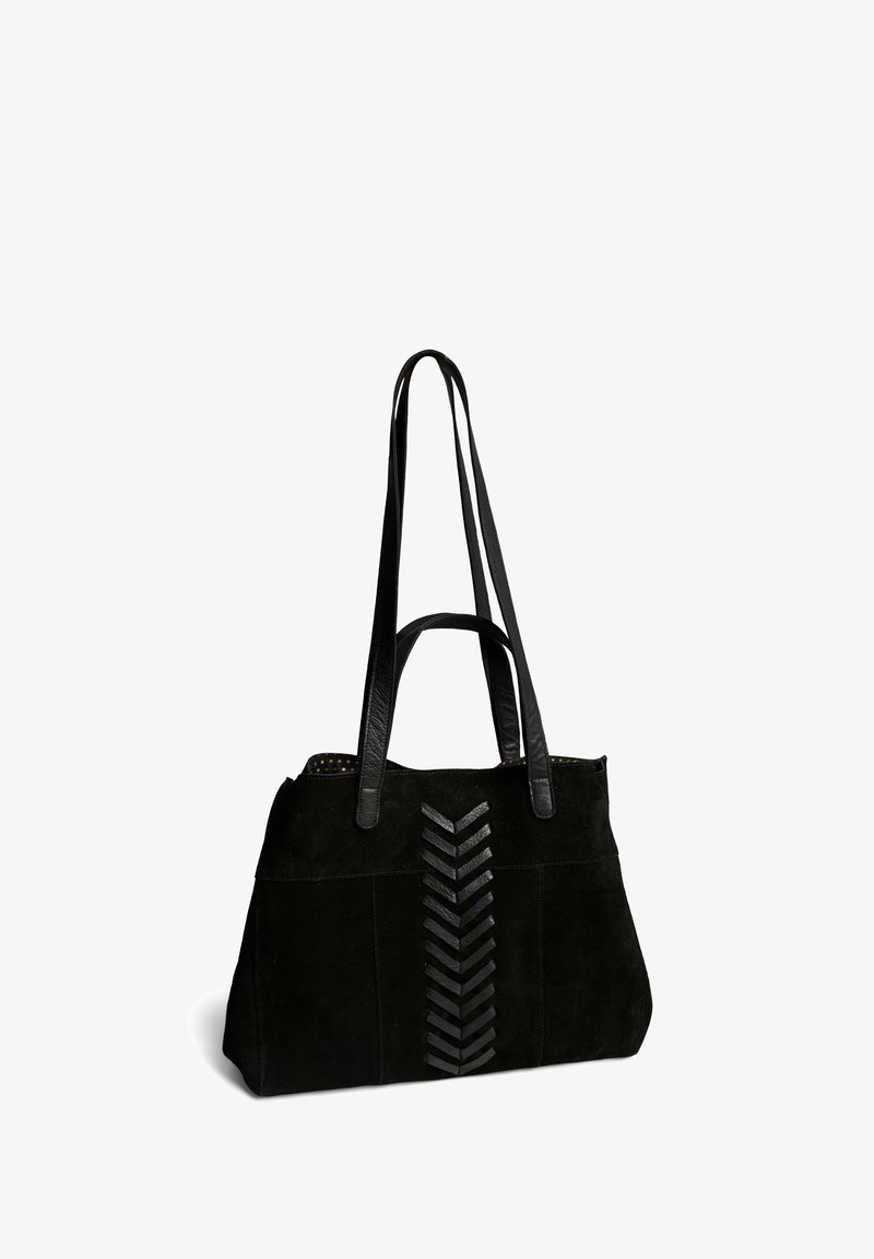 Sac fourre-tout en suède noir avec des poignées en cuir et un design zigzag texturé à l'avant, présentant une doublure intérieure à pois.