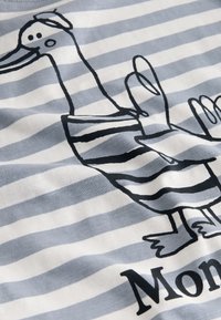 Striped cotton T-shirt in light blue and white featuring a cartoon duck in black outline, with a sailor-style hat and raised wing.