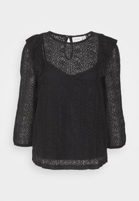Top in pizzo nero con scollo rotondo, maniche a tre quarti e orlo ondulato, caratterizzato da motivi intricati e una vestibilità leggermente morbida.