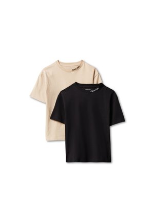 Deux t-shirts unis à manches courtes avec col ras du cou, un beige et un noir, tous deux avec le logo "Calvin Klein" près de l'encolure.